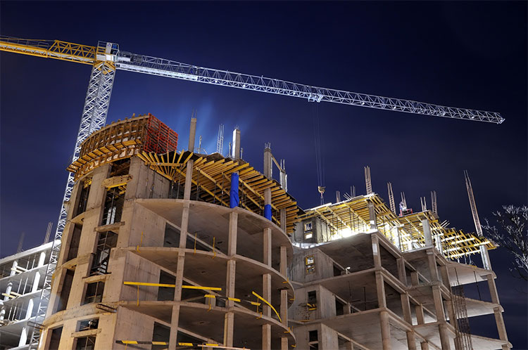 crane and construction site at night