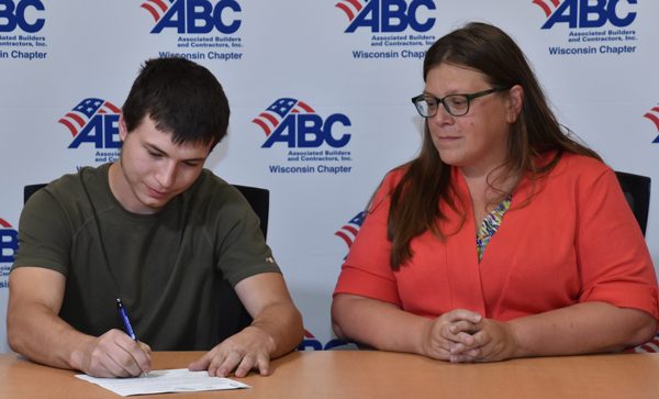 apprentice signing paperwork