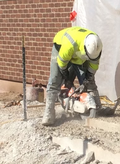 man sawing concrete