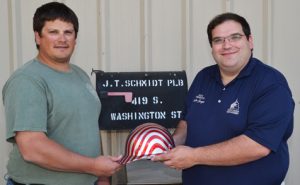 two men holding hard hat