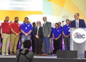 group of ABC members on stage with award