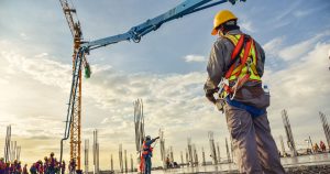 construction employees on job site with crane