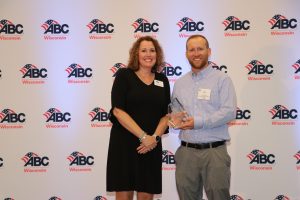 Ken Dickerson receives the Instructor of the Year Award from Leigh Emrick of ABC of Wisconsin.