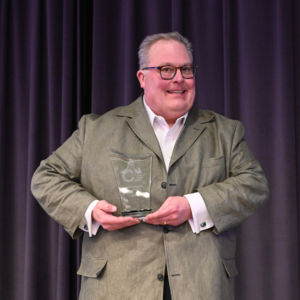 John Schulze poses with his award.
